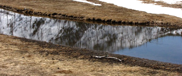 The Madison River Reflects a Hill