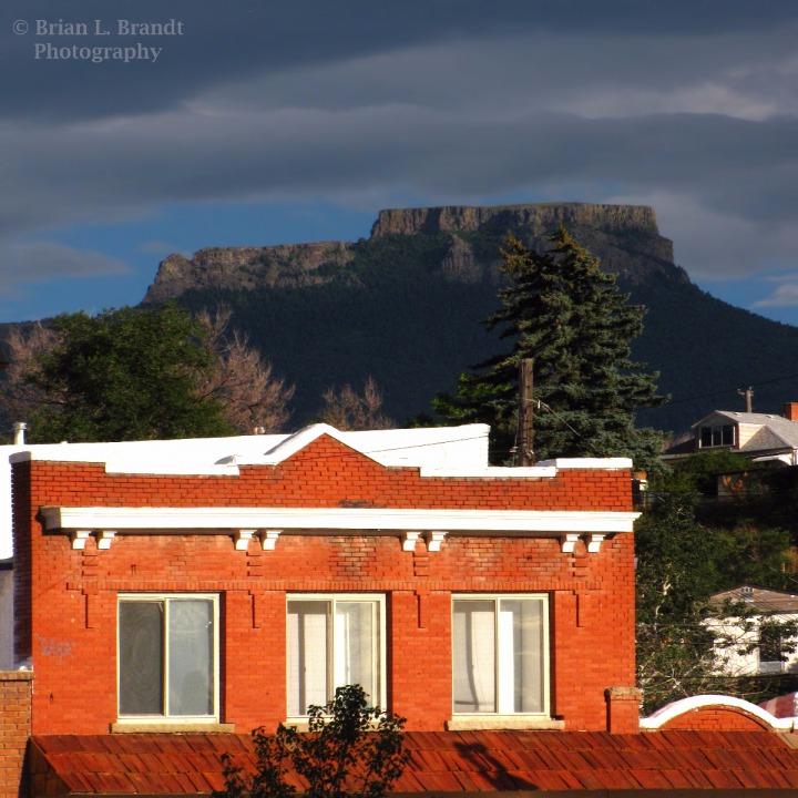 Low Sun Blasts Red Brick in Trinidad CO, with Fishers Peak as a Backdrop