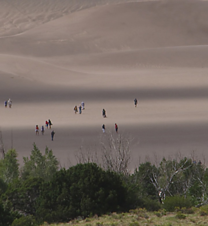 Hikers Dwarfed By the Massive Dunes